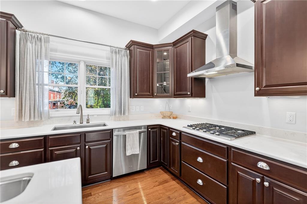 4709 Wallingford Street Pittsburgh, PA 15213 - Photo 10 of 39 a kitchen with stainless steel appliances granite countertop a sink a stove cabinets and wooden floor