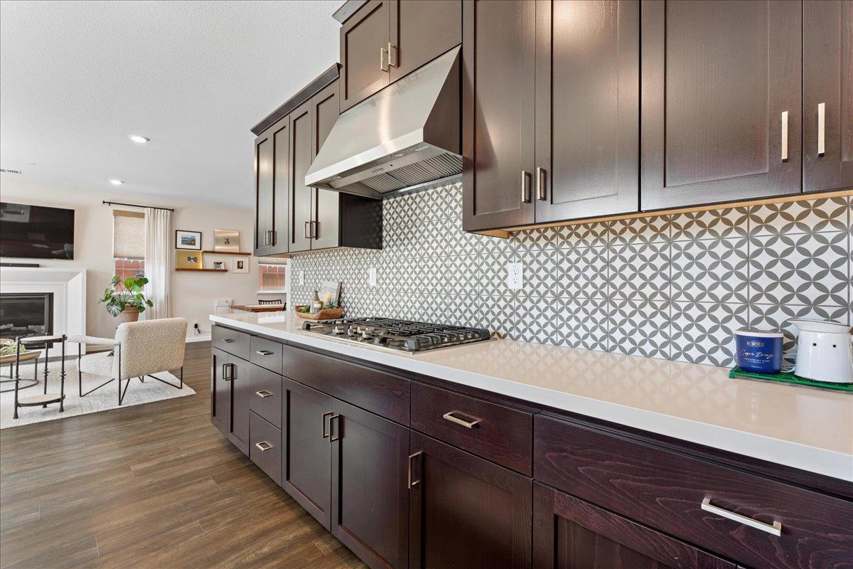 823 Riley Lane Lincoln, CA 95648 - Photo 11 of 52 a kitchen with stainless steel appliances a sink dishwasher stove refrigerator and microwave with wooden floor