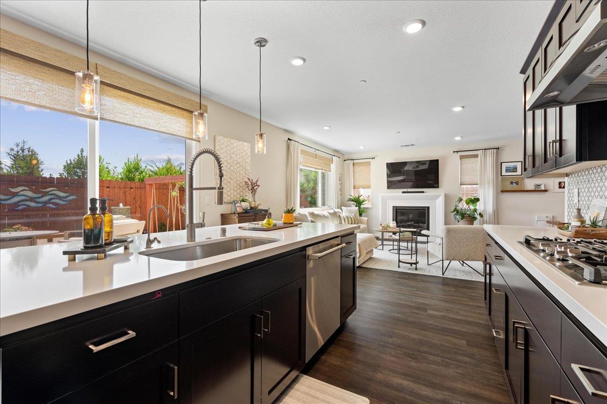 823 Riley Lane Lincoln, CA 95648 - Photo 10 of 52 a kitchen with stainless steel appliances granite countertop a sink a stove and a wooden floors