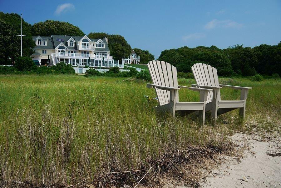 a view of a house with a yard and sitting area