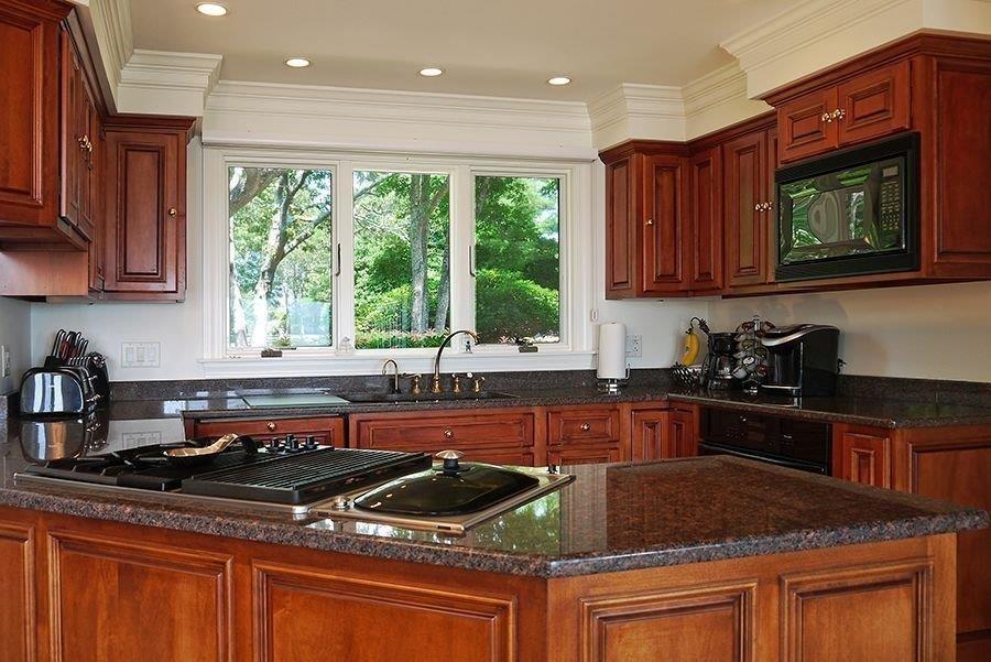 13 Pine Tree Drive Buzzards Bay, MA 02532 - Photo 11 of 30 a kitchen with stainless steel appliances granite countertop a stove a sink and a microwave