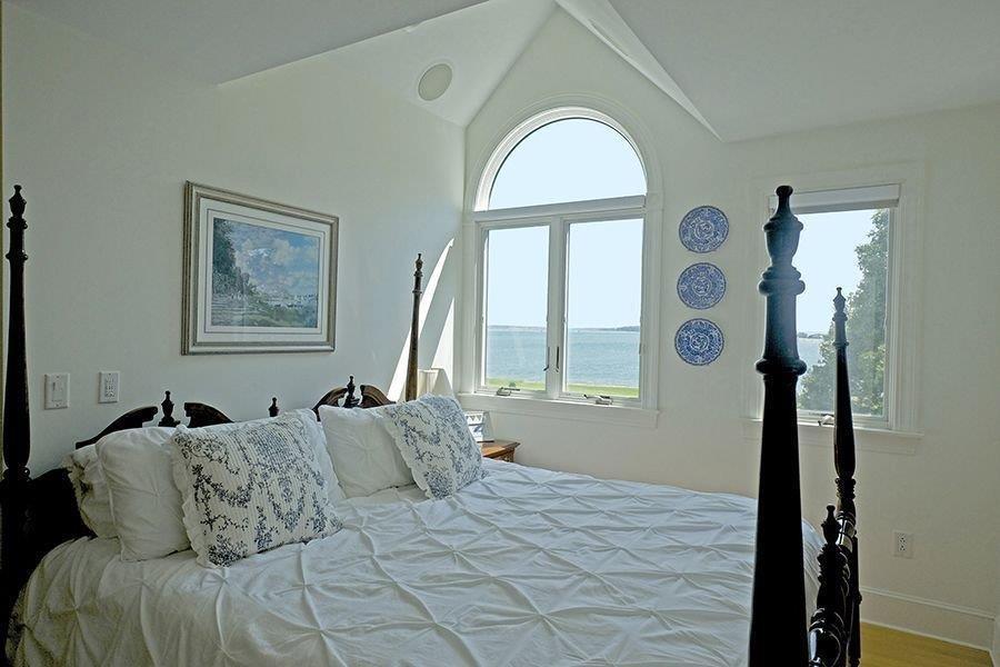 13 Pine Tree Drive Buzzards Bay, MA 02532 - Photo 12 of 30 a bedroom with a bed and a large window