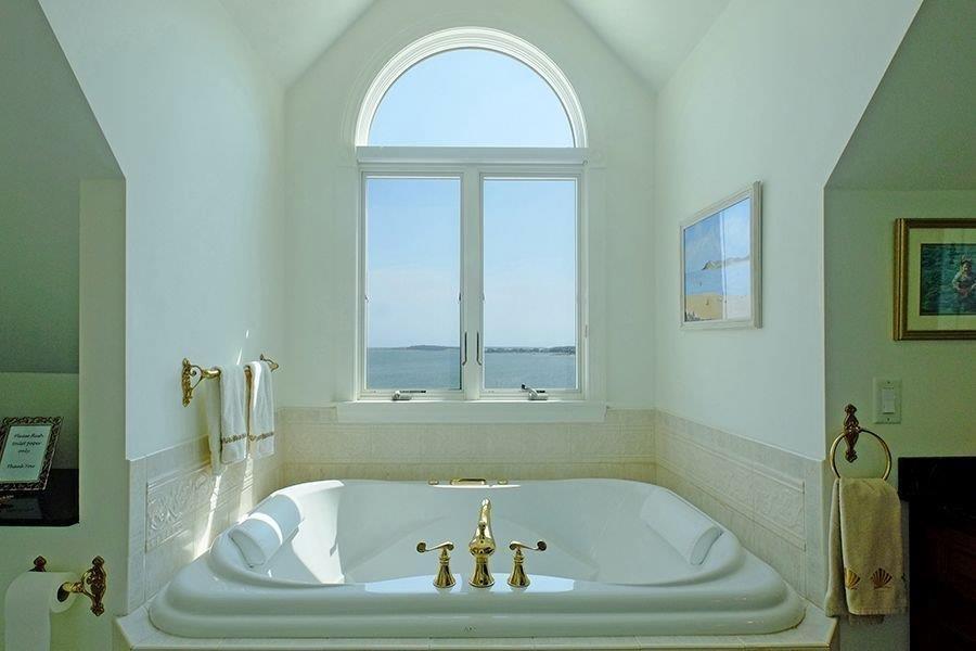 13 Pine Tree Drive Buzzards Bay, MA 02532 - Photo 13 of 30 a bath tub sitting in a bathroom next to a window
