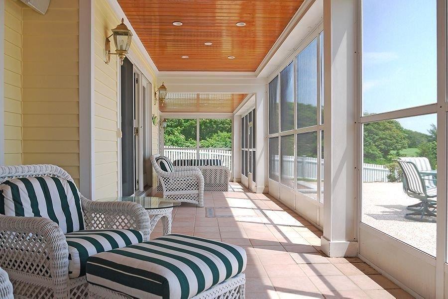 13 Pine Tree Drive Buzzards Bay, MA 02532 - Photo 15 of 30 a balcony view with a large window and outdoor seating