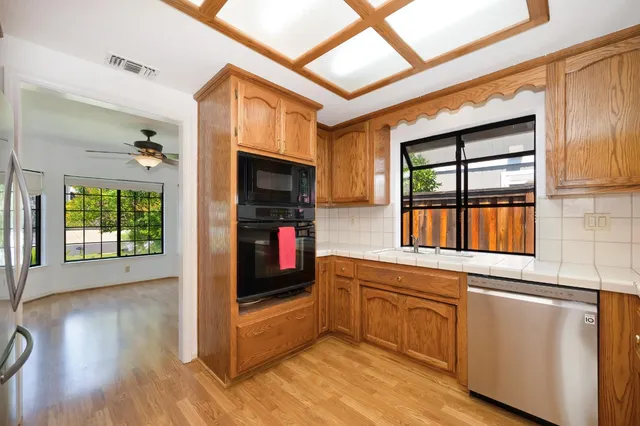 a kitchen with stainless steel appliances granite countertop a sink and cabinets
