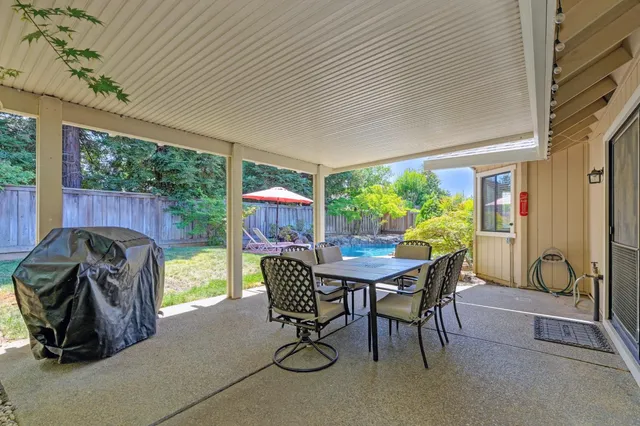 a outdoor dining space with furniture and garden view