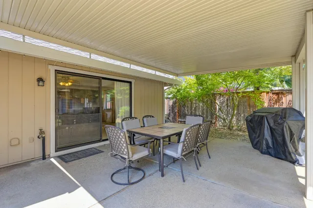 a view of a house with backyard porch and sitting area