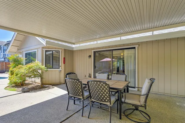 a view of a house with backyard porch and sitting area