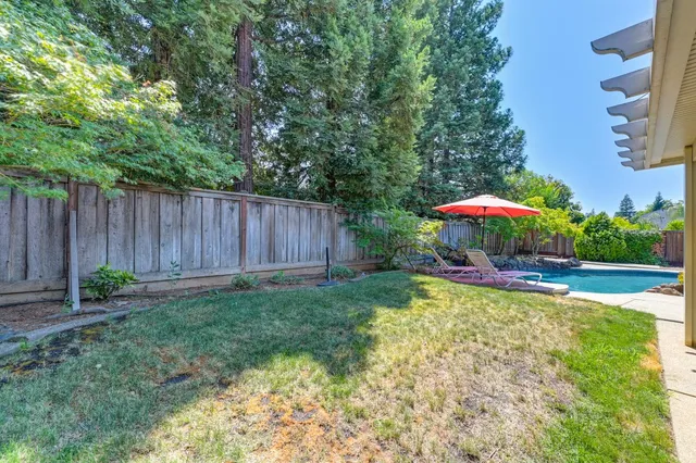 a view of a backyard with sitting area