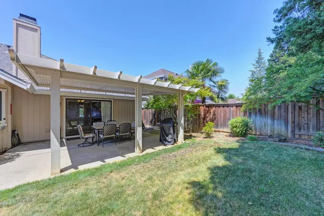 a view of a backyard with sitting area and furniture