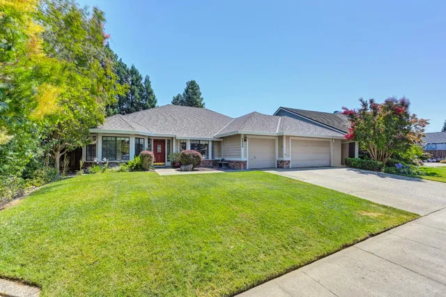 a front view of a house with garden and porch