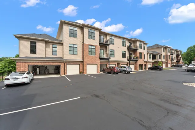 a car parked in front of a white house