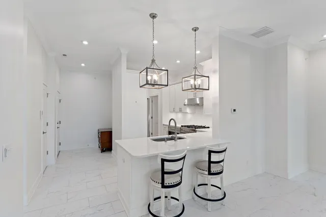 a kitchen with stainless steel appliances a stove sink and cabinets