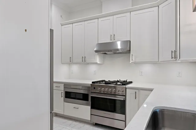 a kitchen with stainless steel appliances a refrigerator and a stove