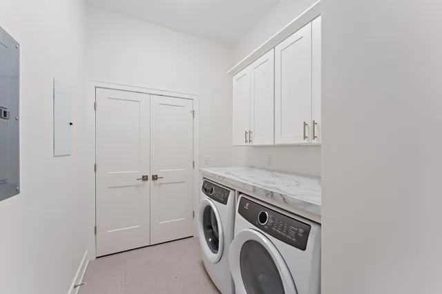 a kitchen with stainless steel appliances a refrigerator a sink a stove and white cabinets