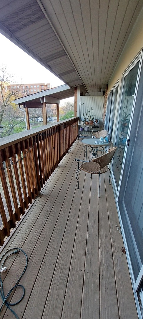 5854 Forest View Road, Unit E Lisle, IL 60532 - Photo 14 of 18 a view of balcony with wooden floor and outdoor seating