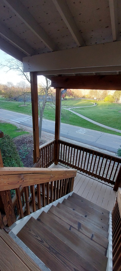 5854 Forest View Road, Unit E Lisle, IL 60532 - Photo 16 of 18 a view of a wooden deck with a ocean view