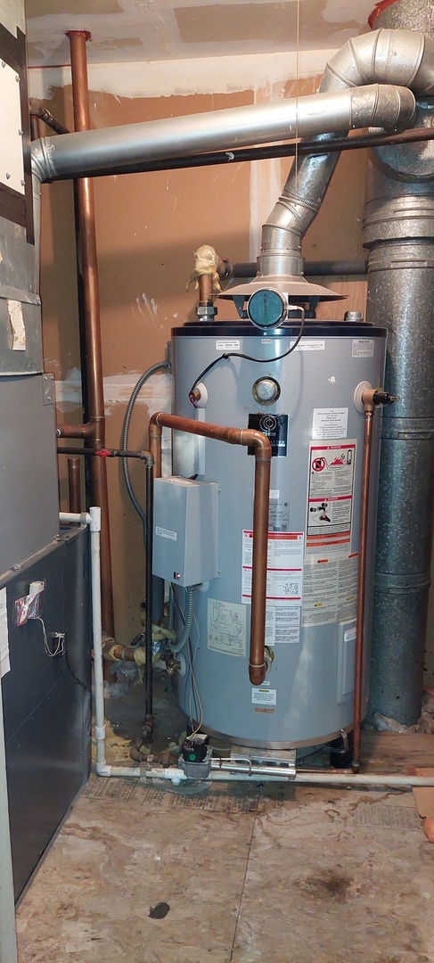 5854 Forest View Road, Unit E Lisle, IL 60532 - Photo 17 of 18 a room with water heater and wooden cabinets