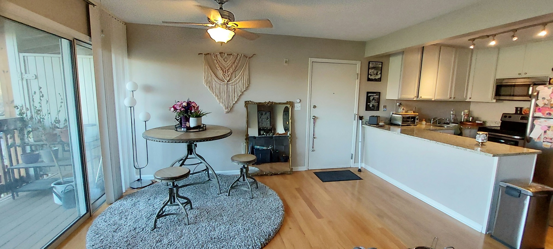 5854 Forest View Road, Unit E Lisle, IL 60532 - Photo 5 of 18 a kitchen with stainless steel appliances granite countertop a refrigerator a sink dishwasher a dining table and chairs with wooden floor