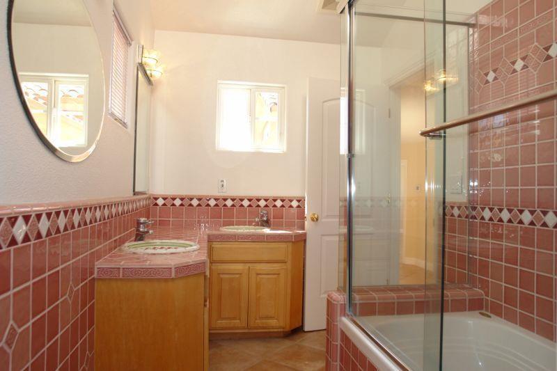4450 Quimby Road San Jose, CA 95148 - Photo 19 of 19 a bathroom with a mirror a bathtub and shower