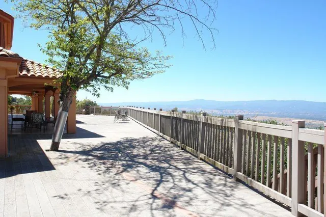 a view of a pathway with a wrought fence