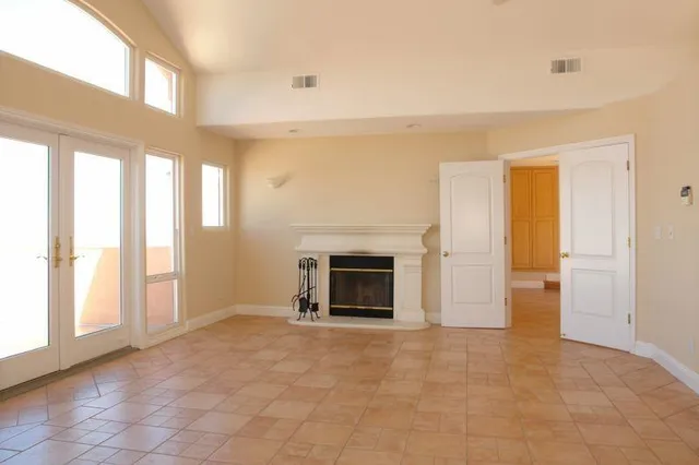 a view of an empty room with a fireplace