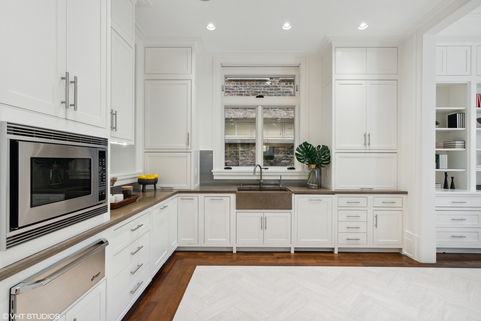 2026 North Mohawk Street Chicago, IL 60614 - Photo 13 of 56 a kitchen with granite countertop white cabinets and white appliances