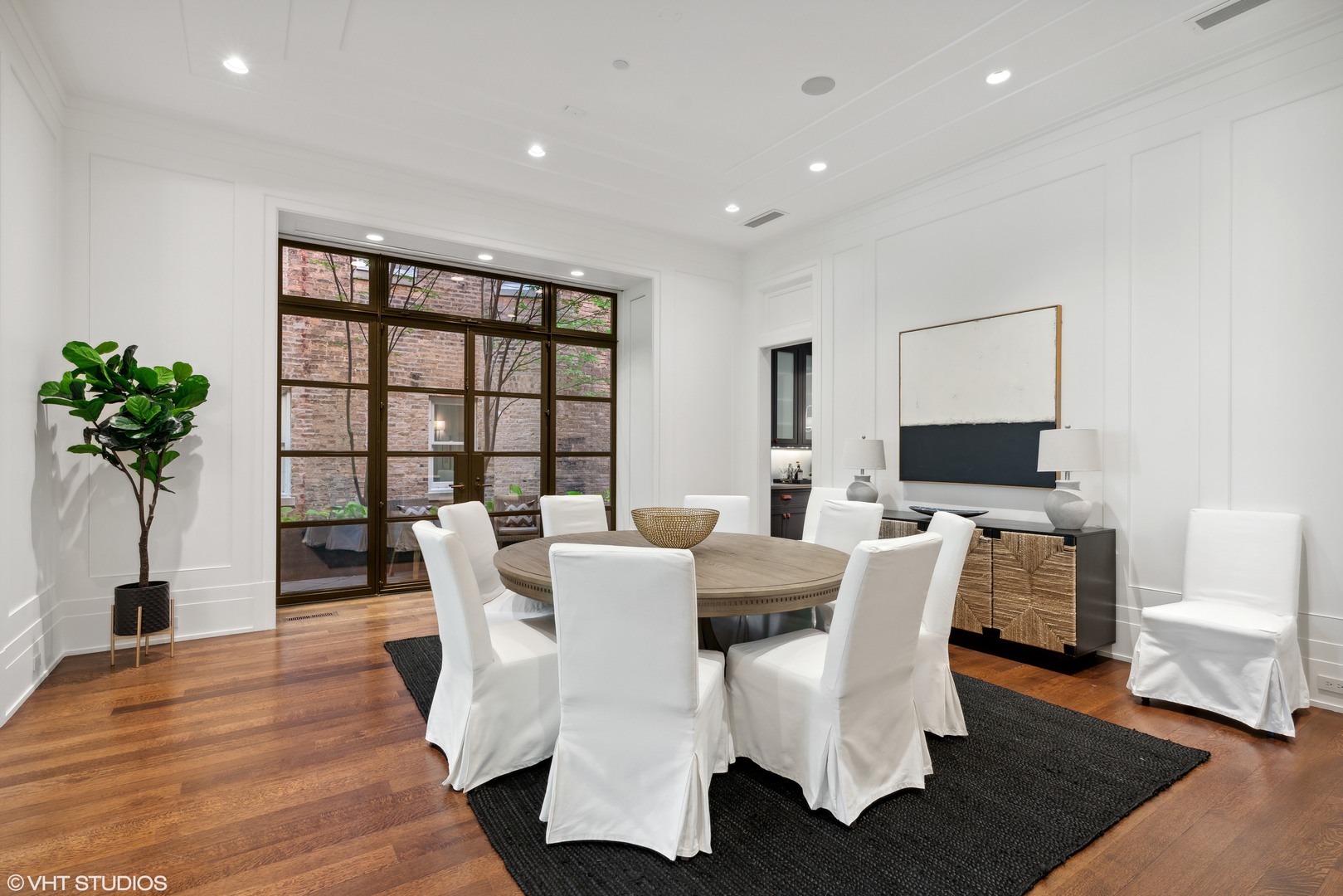 2026 North Mohawk Street Chicago, IL 60614 - Photo 9 of 56 a dining room with furniture potted plants and wooden floor