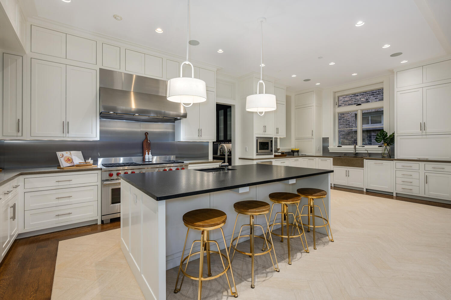 2026 North Mohawk Street Chicago, IL 60614 - Photo 10 of 56 a kitchen with stainless steel appliances granite countertop wooden cabinets and chairs