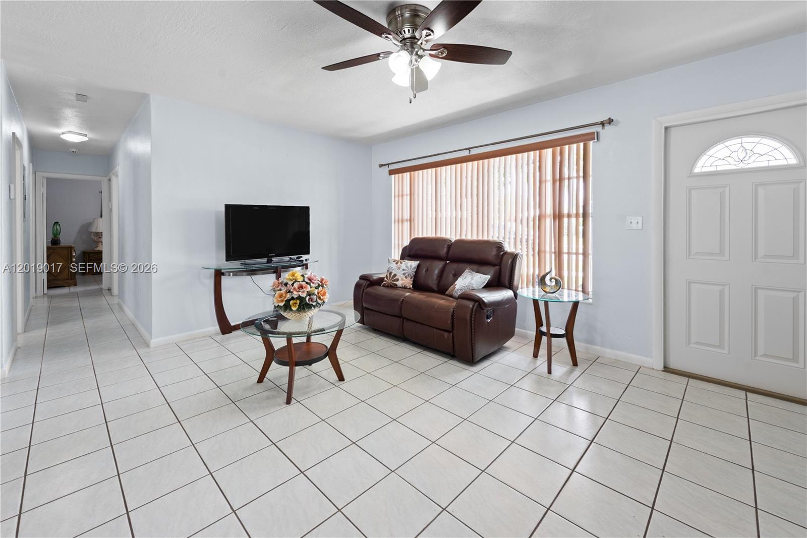 731 Northwest 17th Street Homestead, FL 33030 - Photo 3 of 29 a living room with furniture and a flat screen tv