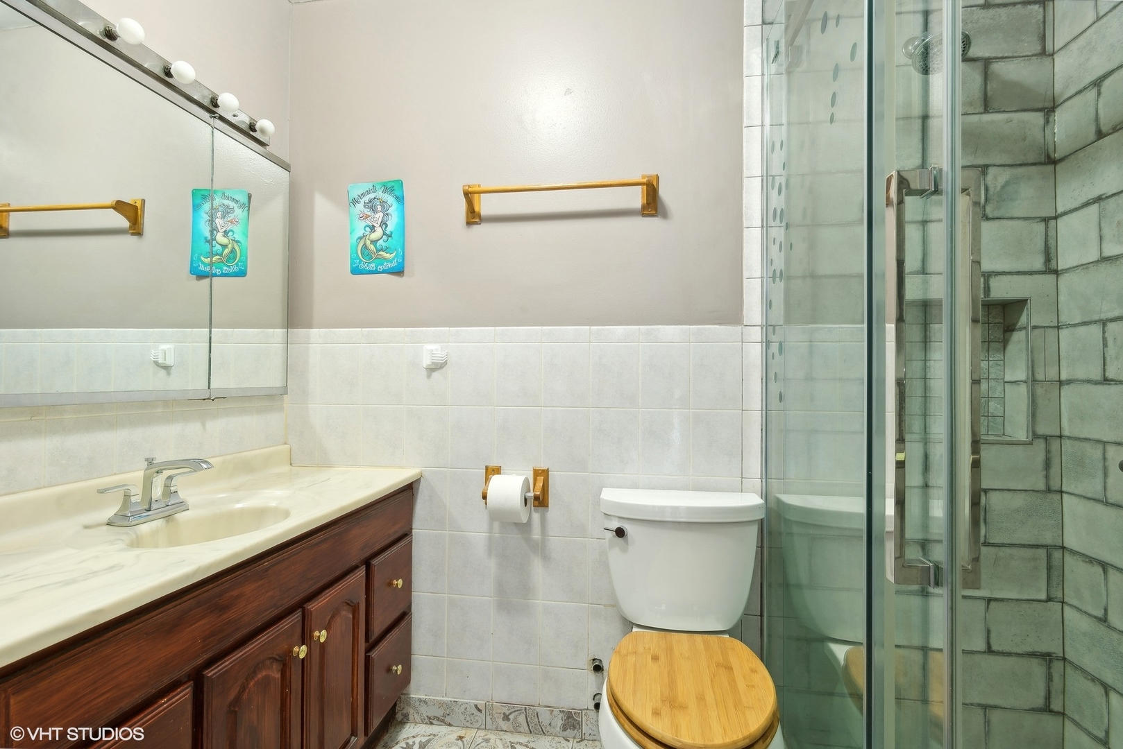 5445 North Sheridan Road, Unit 403 Chicago, IL 60640 - Photo 6 of 11 a bathroom with a toilet a sink and mirror
