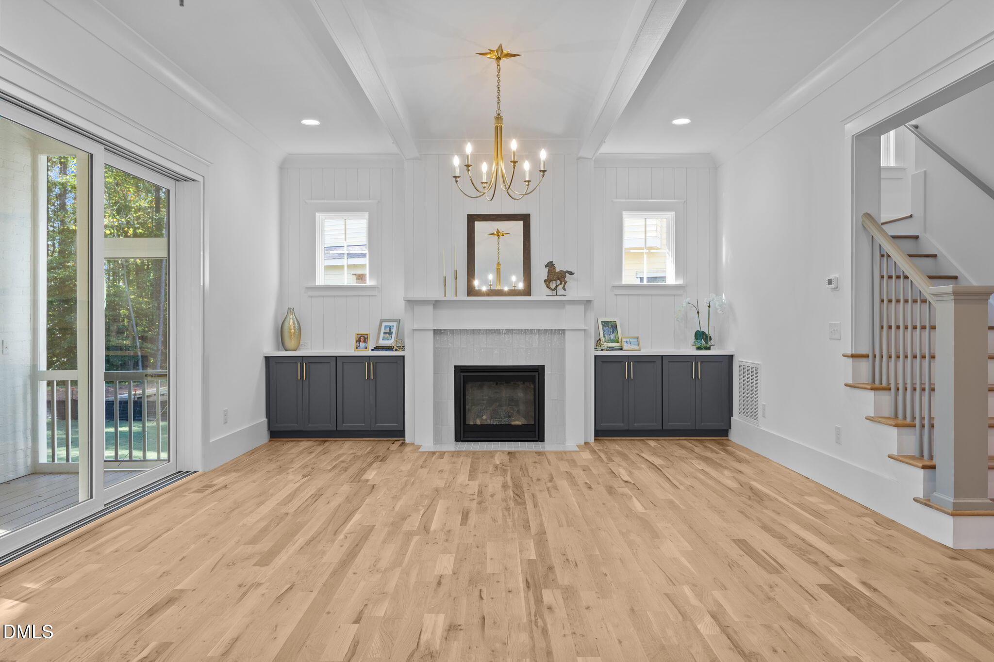 1701 Burnette Gdn Path Raleigh, NC 27612 - Photo 13 of 49 a view of a livingroom with a fireplace chandelier and windows