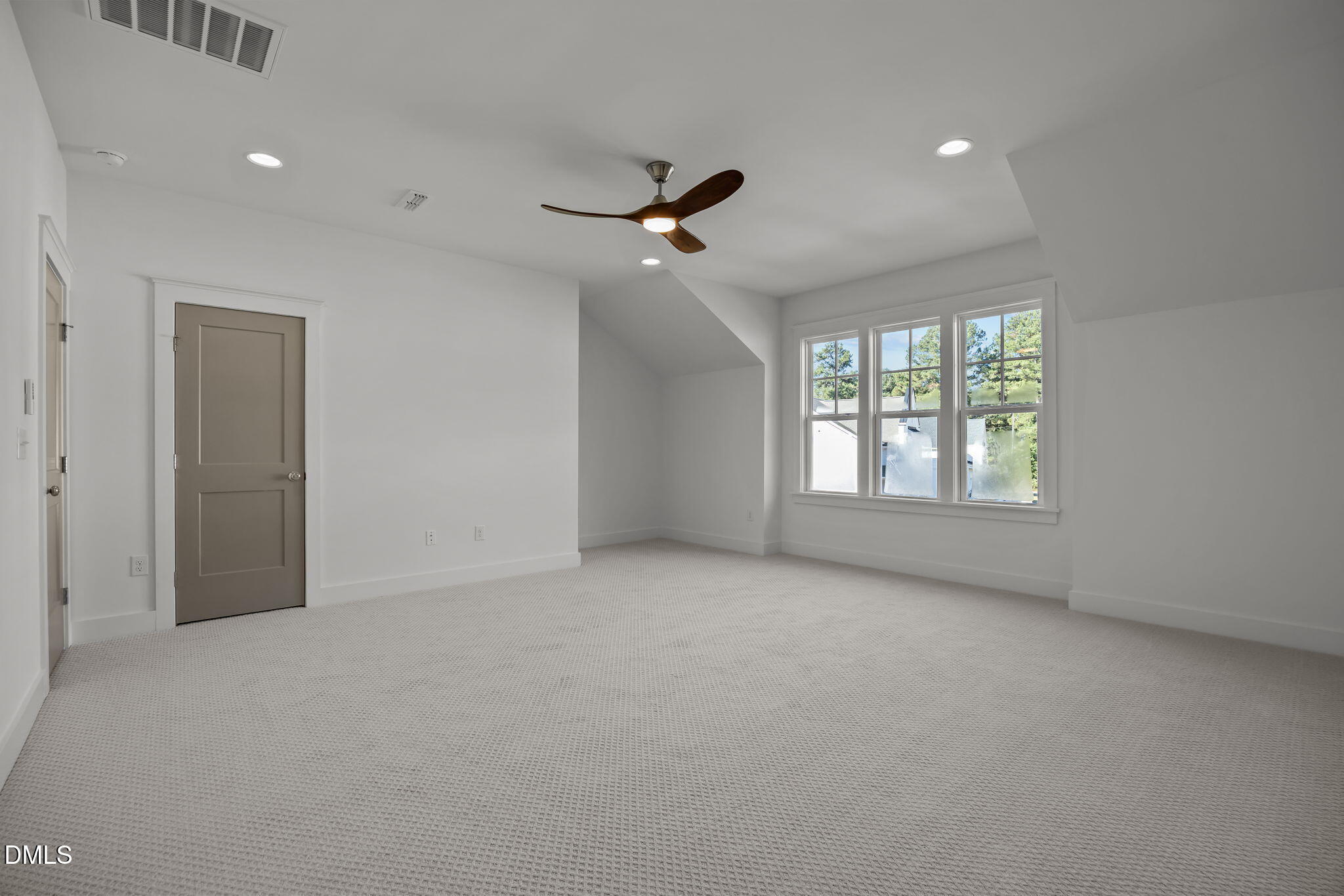1701 Burnette Gdn Path Raleigh, NC 27612 - Photo 37 of 49 an empty room with ceiling fan and windows