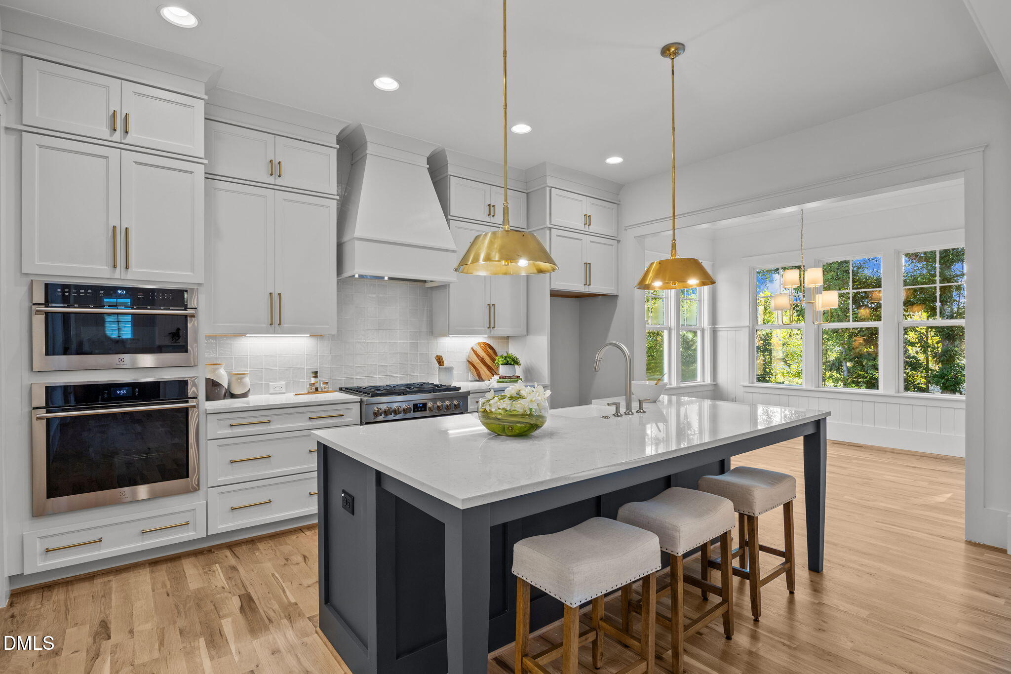 1701 Burnette Gdn Path Raleigh, NC 27612 - Photo 8 of 49 a kitchen with stainless steel appliances granite countertop a stove a refrigerator a kitchen island a sink and chairs