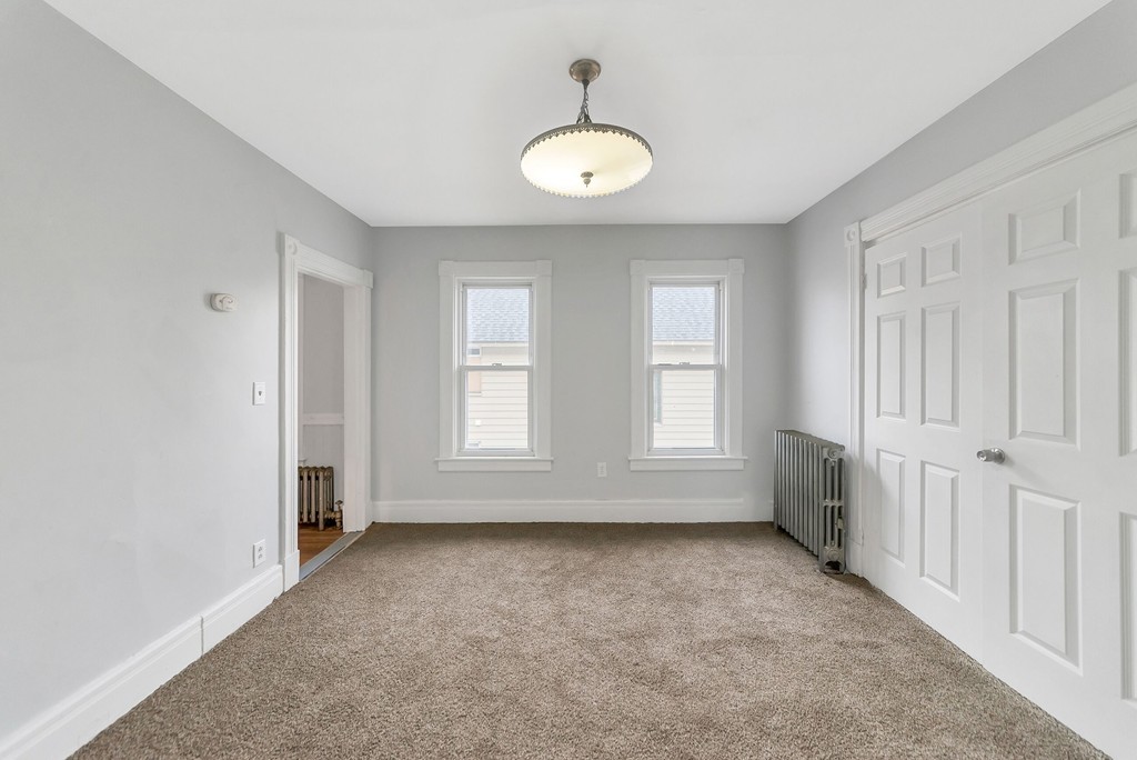 73 Cleveland Street Springfield, MA 01104 - Photo 5 of 21 an empty room with windows