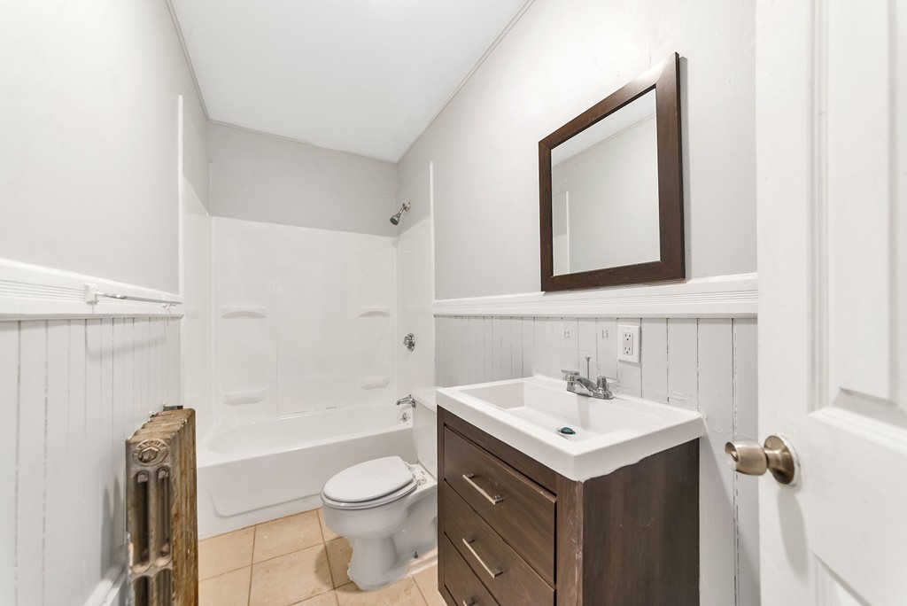 73 Cleveland Street Springfield, MA 01104 - Photo 10 of 21 a bathroom with a toilet sink and mirror