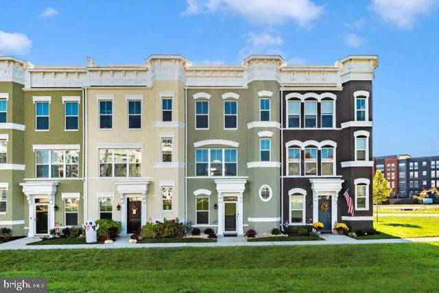 a front view of a residential apartment building with a yard