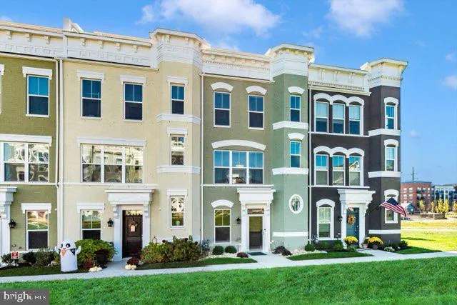 a front view of a residential apartment building with a yard