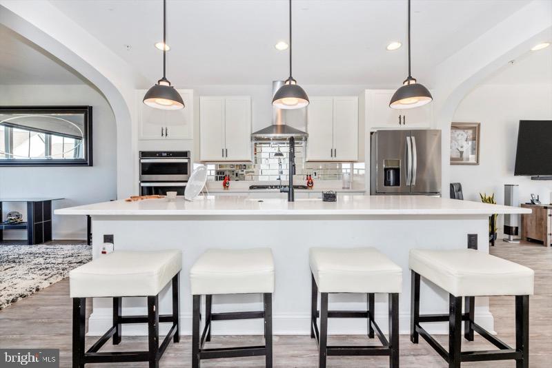 952 Holden Road Frederick, MD 21701 - Photo 8 of 20 a kitchen that has a table chairs and a wooden floor