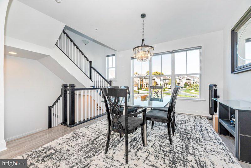 952 Holden Road Frederick, MD 21701 - Photo 10 of 20 a view of a dining room with furniture window and wooden floor
