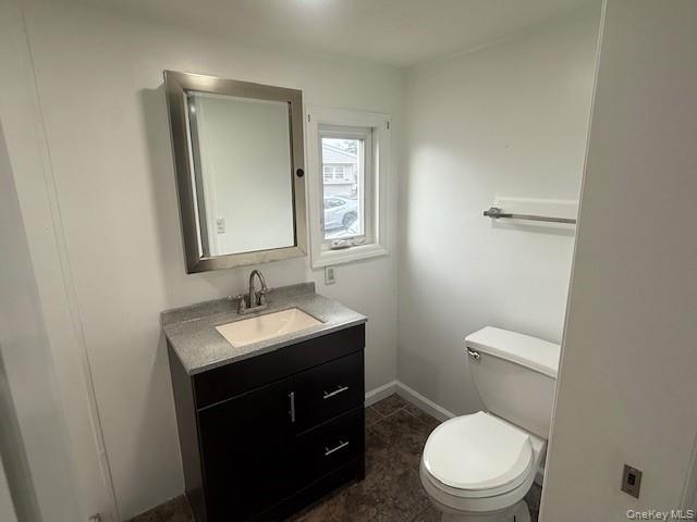 567 Sheafe Road, Unit 10 Wappingers Falls, NY 12590 - Photo 14 of 21 a bathroom with a toilet a sink a mirror and vanity
