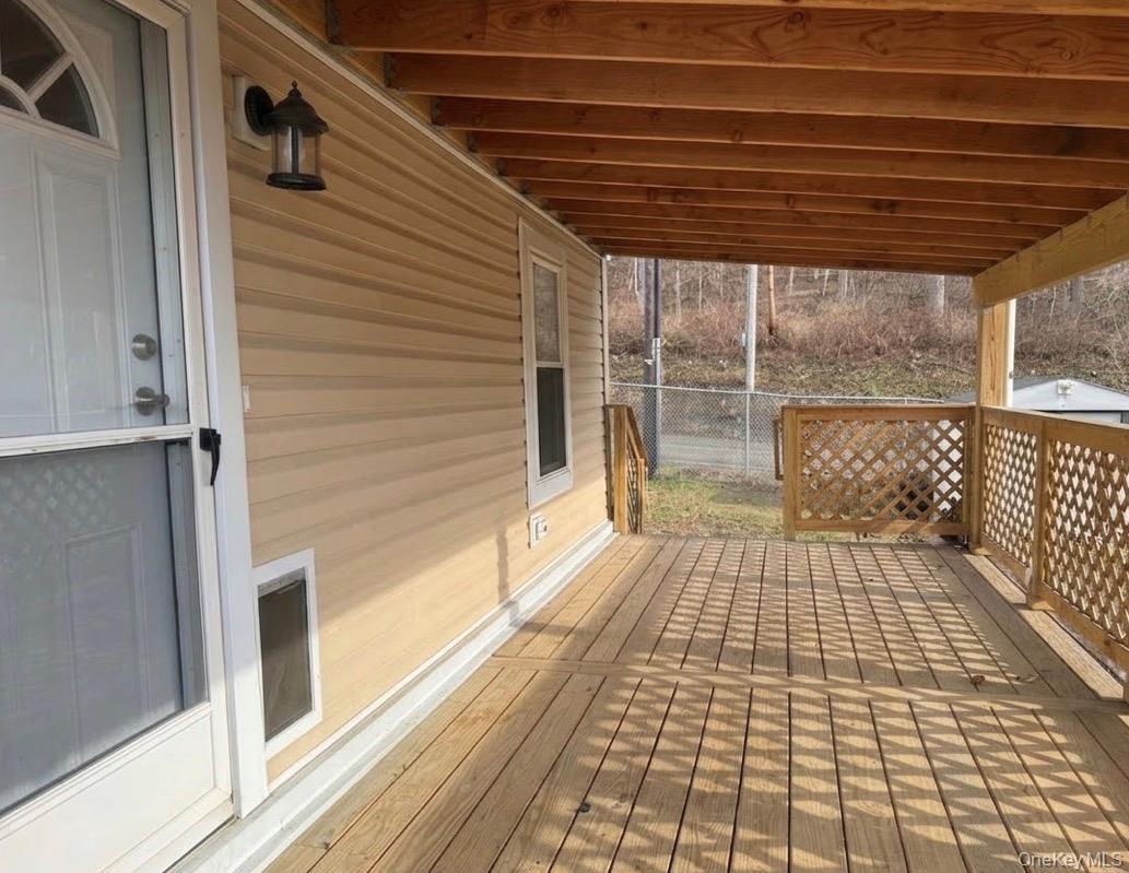 567 Sheafe Road, Unit 10 Wappingers Falls, NY 12590 - Photo 4 of 21 a view of a balcony with wooden floor