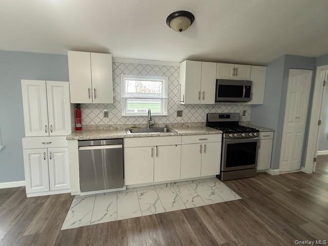 567 Sheafe Road, Unit 10 Wappingers Falls, NY 12590 - Photo 10 of 21 a kitchen with a stove a sink and a microwave