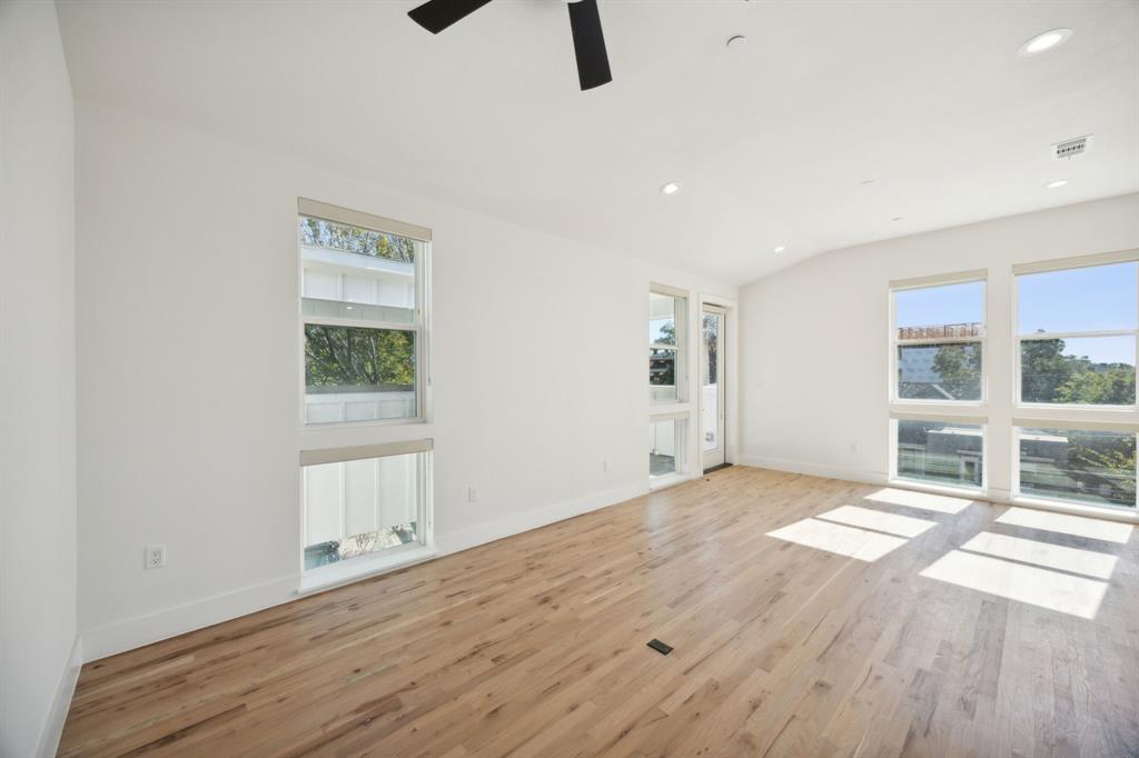 4907 Bryan Street Dallas, TX 75204 - Photo 15 of 21 a view of an empty room with a window and wooden floor
