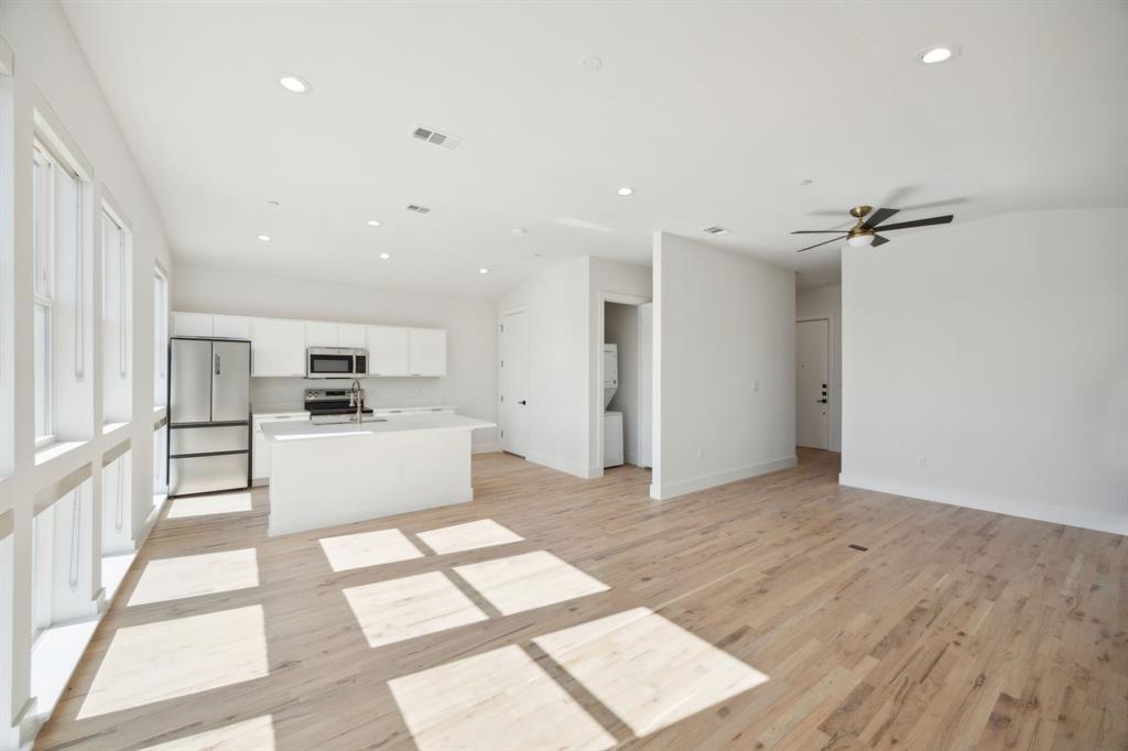 4907 Bryan Street Dallas, TX 75204 - Photo 19 of 21 a view of kitchen with cabinets and wooden floor