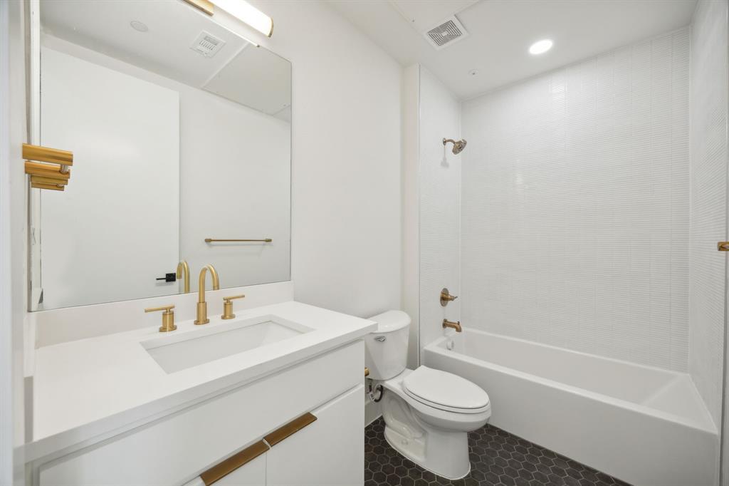 4907 Bryan Street Dallas, TX 75204 - Photo 6 of 21 a bathroom with a sink a toilet and shower