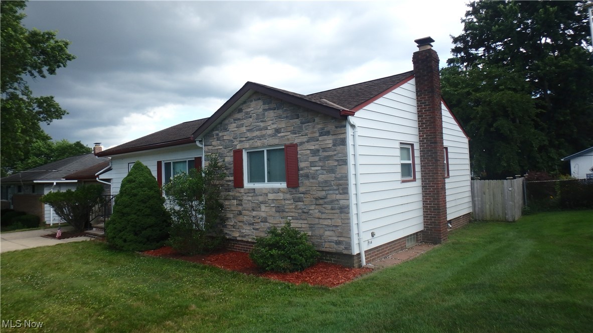 2901 Dentzler Road Parma, OH 44134 - Photo 3 of 25 View of side of home featuring a chimney and stone siding
