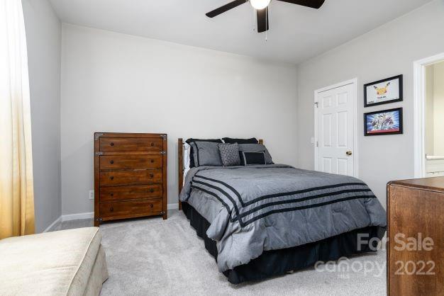 903 Azurine Circle Fort Mill, SC 29708 - Photo 11 of 19 a bedroom with a bed and a chandelier