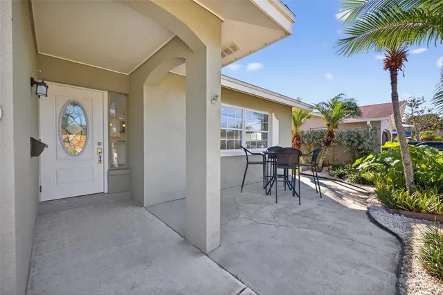 a view of a patio with table and chairs and potted plants