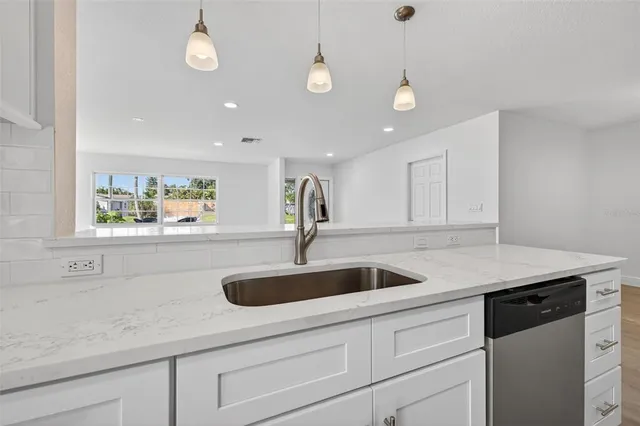 a kitchen with a sink and window